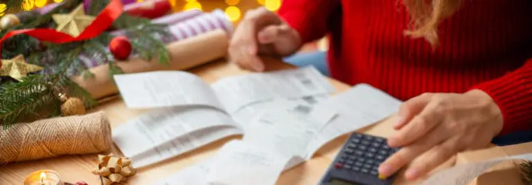 woman adding up receipts during the holidays