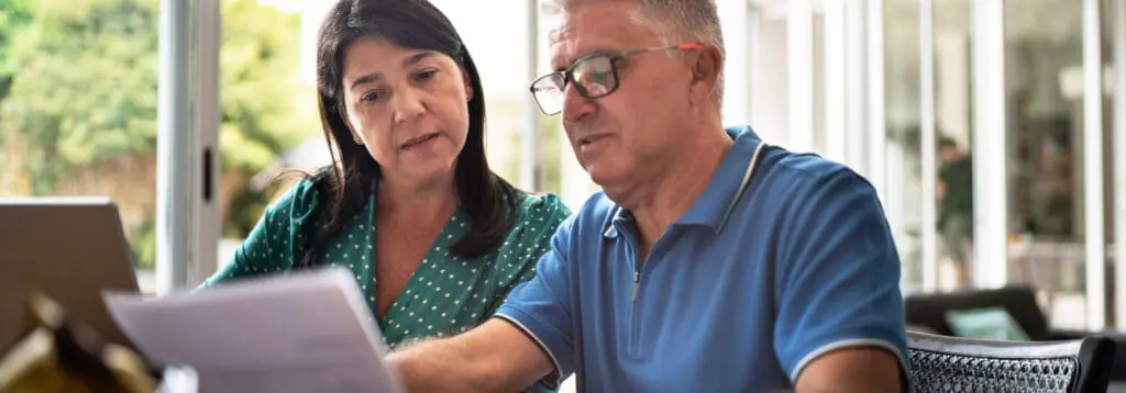 older couple looking carefully at a document