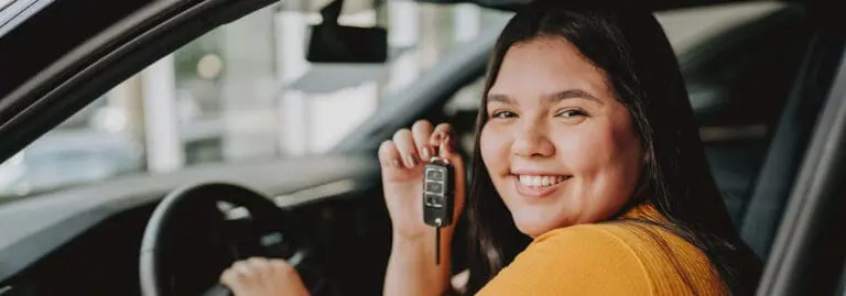 young woman in new car