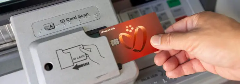 closeup of a credit card being used at an ATM